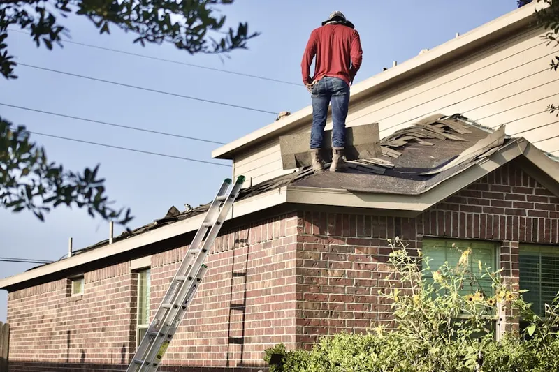 Professional roofer working on a residential roof in East Central Boulevard